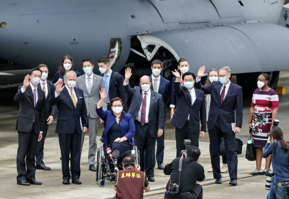 A delegation comprised of Senators Tammy Duckworth (3rd L), Christoper Coons (3rd R), and Dan Sullivan (2nd L), poses for photographs with Taiwan's Foreign Minister Joseph Wu (2nd R) and American Institute in Taiwan (AIT) Director Brent Christensen (R) following their arrival at the Songshan Airport in Taipei on June 6, 2021. (Pei Chen/POOL/AFP via Getty Images)