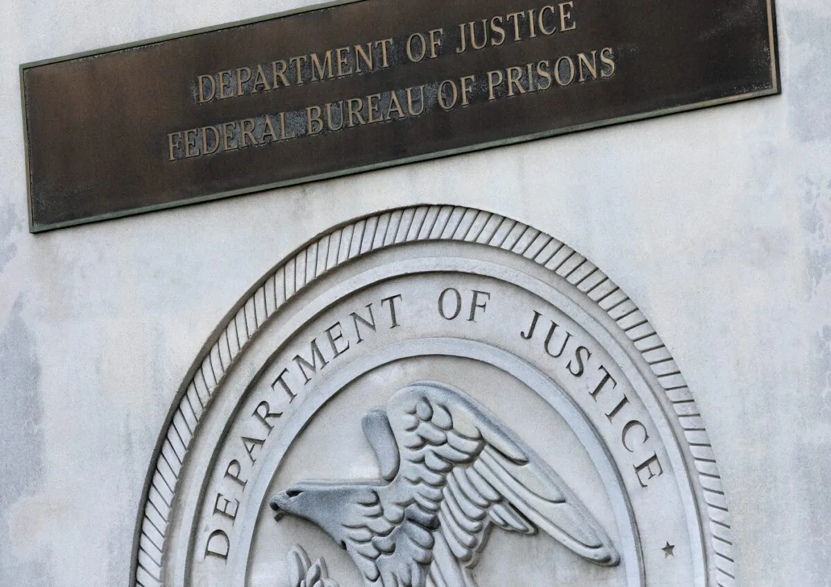 A sign for the Department of Justice Federal Bureau of Prisons is displayed at the Metropolitan Detention Center in the Brooklyn borough of New York, on July 6, 2020. (Mark Lennihan/File/AP Photo)