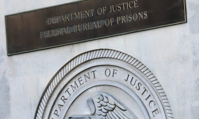 A sign for the Department of Justice Federal Bureau of Prisons is displayed at the Metropolitan Detention Center in the Brooklyn borough of New York, on July 6, 2020. (Mark Lennihan/AP Photo)