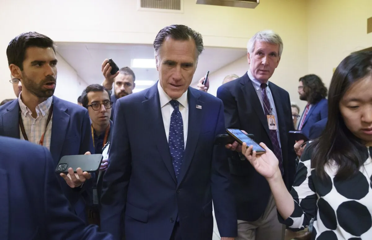 Sen. Mitt Romney (R-Utah) is surrounded by reporters as he walks to the Senate chamber at the Capitol in Washington on June 10, 2021. (J. Scott Applewhite/AP Photo)