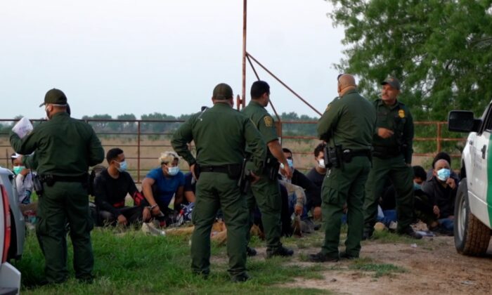 In a still image from a video released by NTD, Border Patrol agents detain illegal immigrants in McAllen, Texas. (Sunny Yang/NTD)