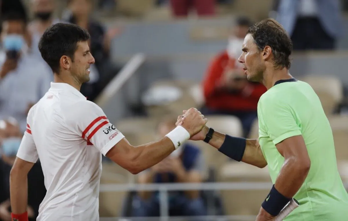 Serbia's Novak Djokovic (L) shakes hands with Spain's Rafael Nadal after winning their semifinal match of the French Open tennis tournament at the Roland Garros stadium in Paris, France, on June 11, 2021. (Sarah Meyssonnier/Reuters)