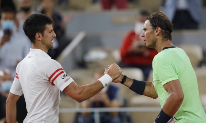 Serbia's Novak Djokovic (L) shakes hands with Spain's Rafael Nadal after winning their semifinal match of the French Open tennis tournament at the Roland Garros stadium in Paris, France, on June 11, 2021. (Sarah Meyssonnier/Reuters)