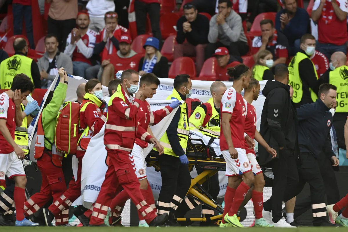 Denmark's Christian Eriksen is taken away on a stretcher after collapsing on the pitch during the Euro 2020 soccer championship group B match between Denmark and Finland at Parken Stadium in Copenhagen, on June 12, 2021. (Stuart Franklin/Pool via AP)