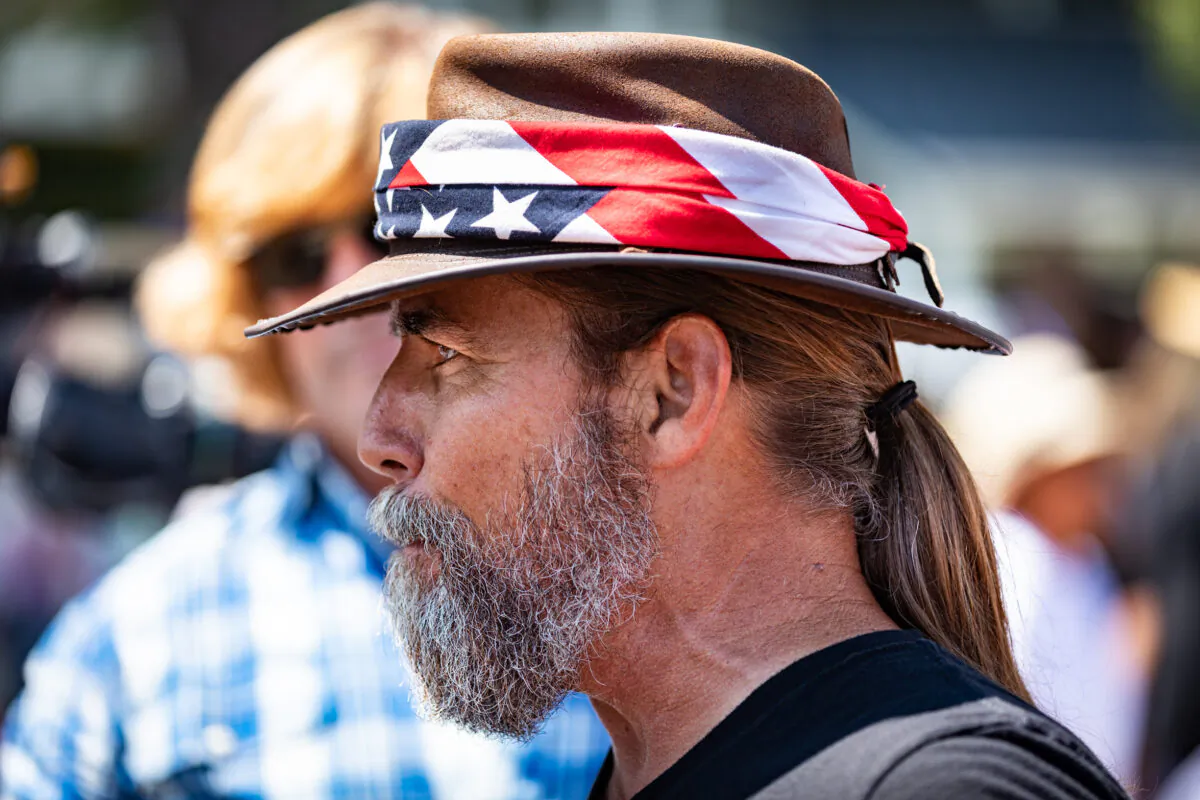Former La Habra police chief Alan Hostetter tells an ABC7 cameraman that "media is the virus" as people gather in front of the Orange County Department of Education to rally support for the reopening of California schools. (John Fredricks/The Epoch Times)