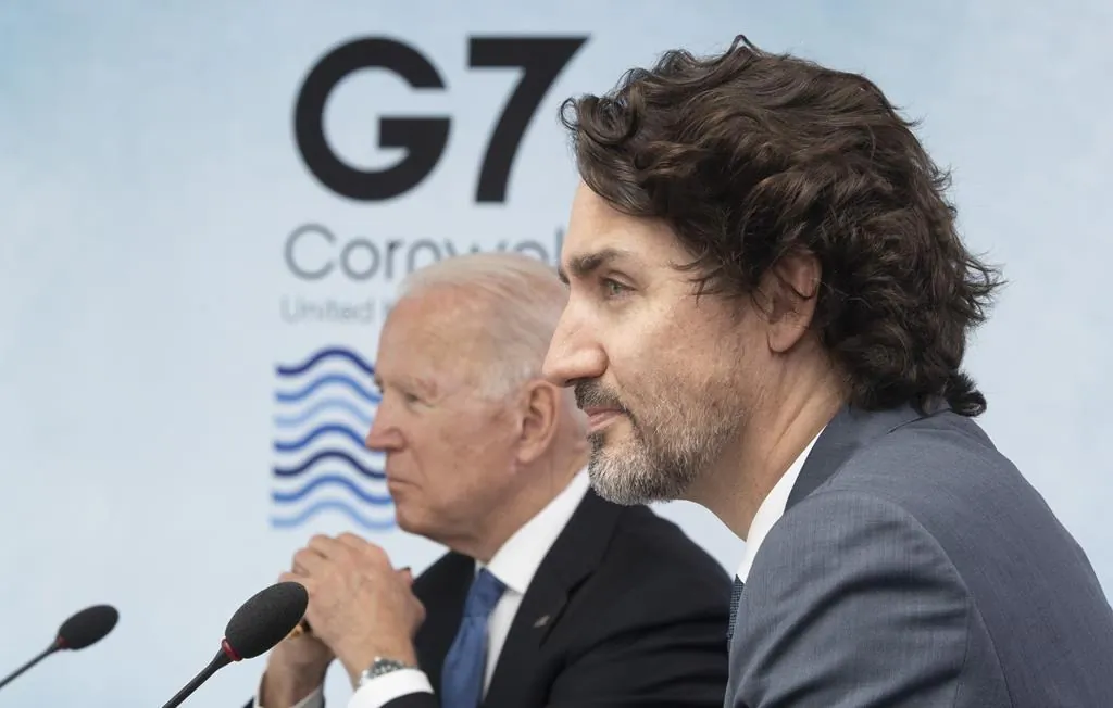 Canadian Prime Minister Justin Trudeau and United States President Joe Biden listen to United Kingdom Prime Minister Boris Johnson deliver opening remarks at a plenary session at the G7 Summit in Carbis Bay, United Kingdom, on June 11, 2021. (The Canadian Press/Adrian Wyld)