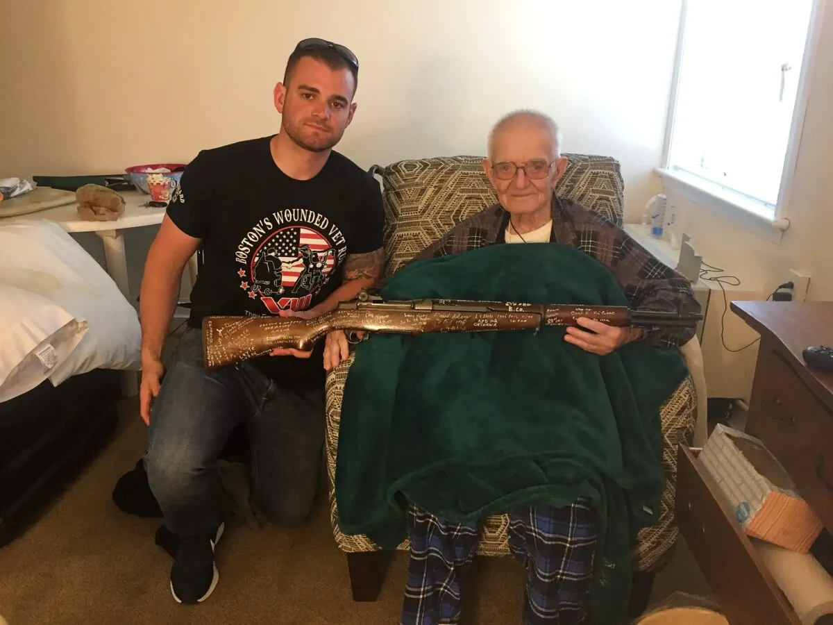 Marine Corps Sgt. Andrew Biggio (L), the author of "The Rifle: Combat Stories from America’s Last WWII Veterans, Told Through an M1 Garand," poses with a WWII veteran. (TheWWIIRifle.com)