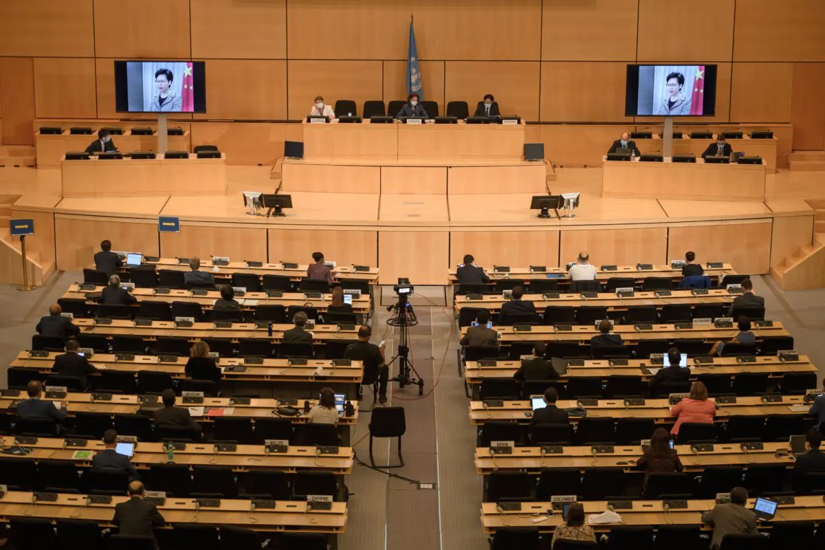 Hong Kong's chief executive Carrie Lam is seen on a giant screens remotely addressing the opening of the UN Human Rights Council's 44th session in Geneva, Switzerland, on June 30, 2020. (Fabrice Coffrini/AFP via Getty Images)