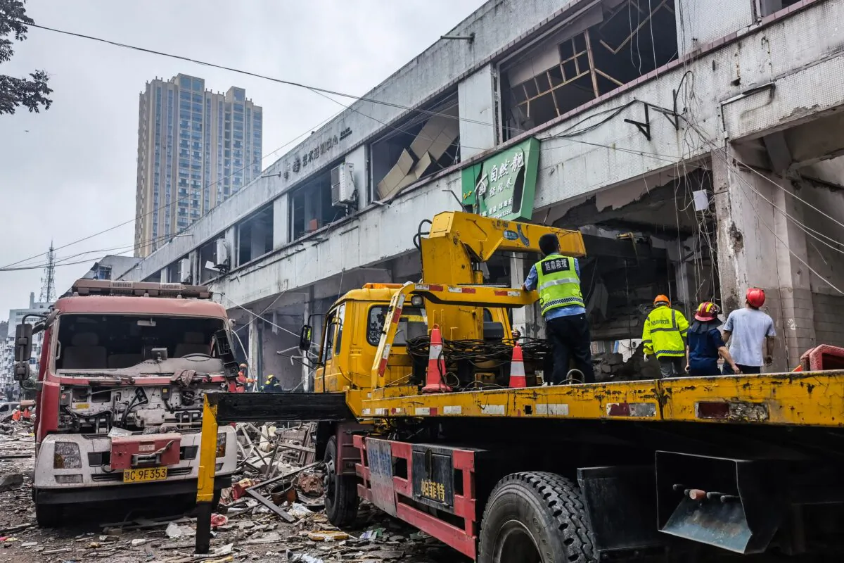Workers search for victims in a building damaged by a gas line explosion in Shiyan, central China's Hubei Province on June 13, 2021. (-/CNS/AFP via Getty Images)
