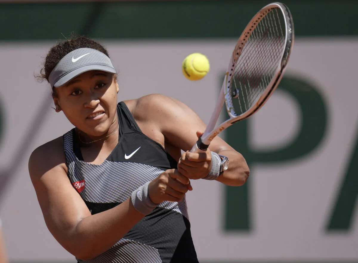 Japan's Naomi Osaka returns the ball to Romania's Patricia Maria Tig during their first round match of the French open tennis tournament at the Roland Garros stadium in Paris, France, on May 30, 2021. (Christophe Ena/AP Photo)