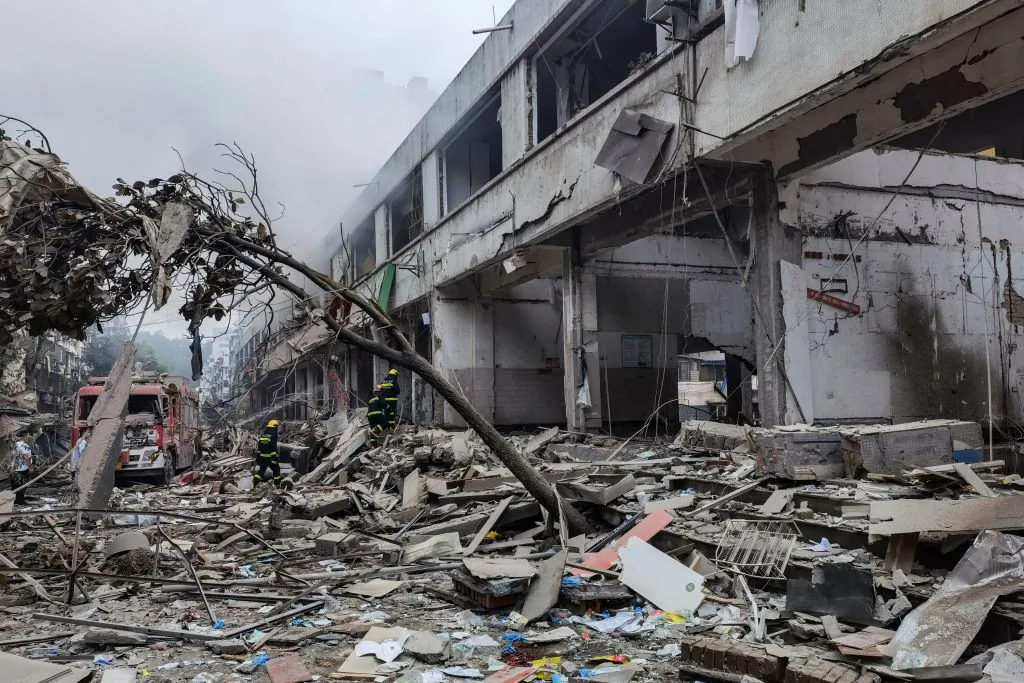 Workers search for victims in a building damaged by a gas line explosion which left at least 12 people dead and nearly 140 others injured in Shiyan, in central China's Hubei province, on June 13, 2021. (CNS/AFP via Getty Images)