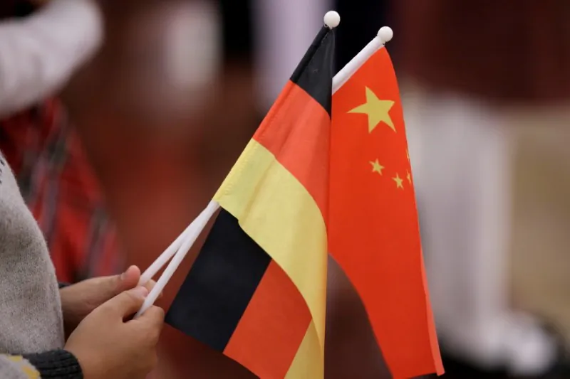 A student holds flags of China and Germany before a welcome ceremony hosted by Chinese leader Xi Jinping for German President Frank-Walter Steinmeier at the Great Hall of the People in Beijing, China, on Dec. 10, 2018. (Jason Lee/Reuters)
