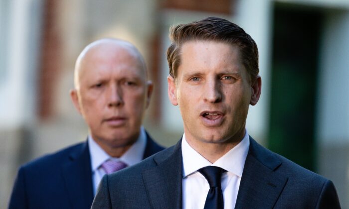 Assistant Defence Minister Andrew Hastie addresses media as Defence Minister Peter Dutton looks on in front of the Subiaco War Memorial in Perth, Australia on April 19, 2021. (AAP Image/Richard Wainwright)