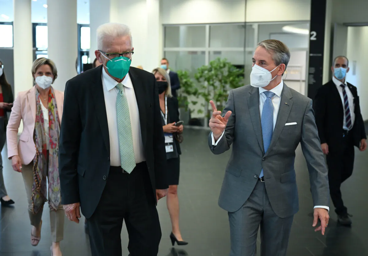 The Governor of Baden-Wuerttemberg, Winfried Kretschmann, front left, and Martin Jetter, front right, CEO of IBM Europe, attend the official inauguration of the first commercially used quantum computer in Europe in Ehningen, Germany, on June 15, 2021. (Bernd Weissbrod/dpa via AP)