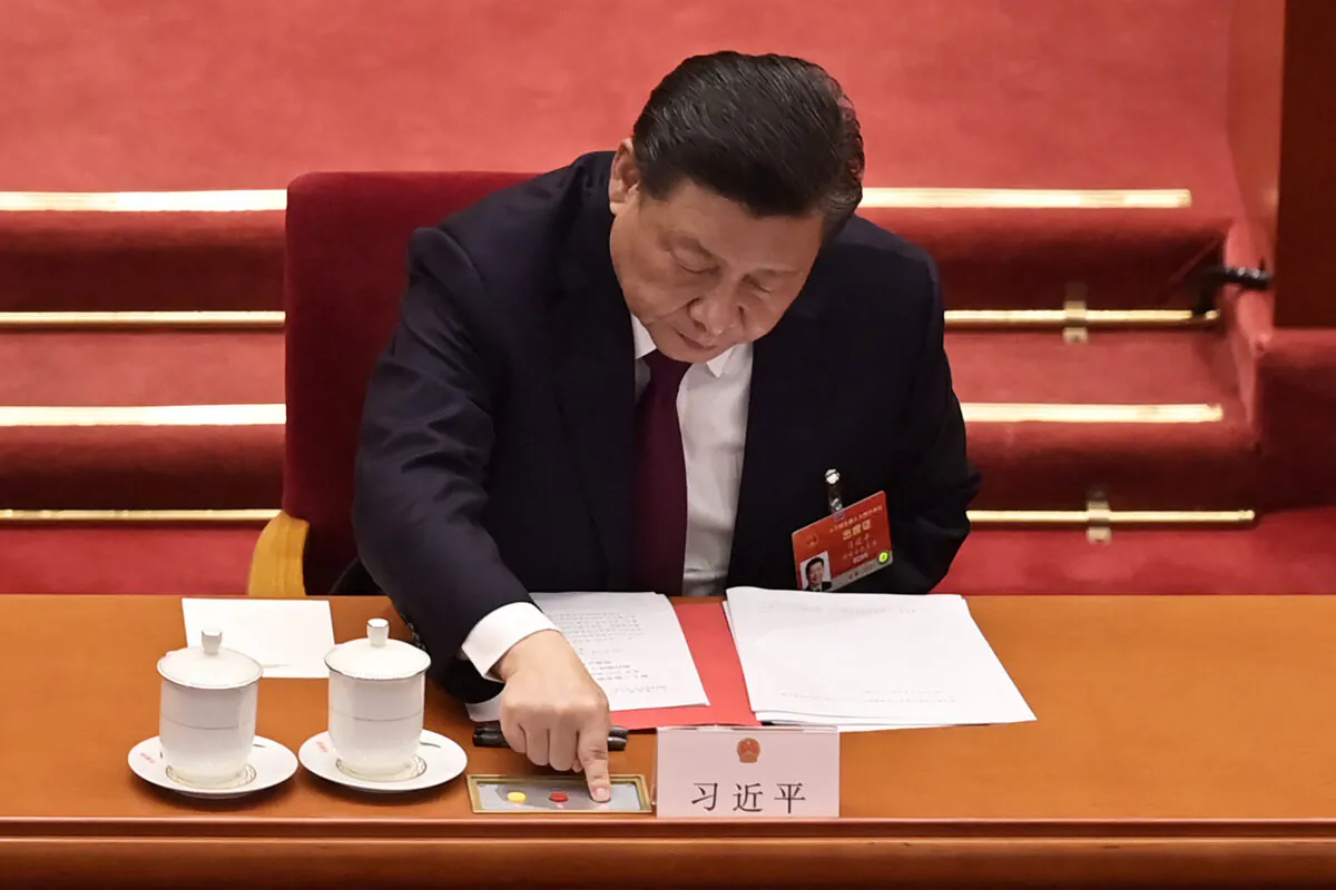 Chinese leader Xi Jinping votes on changes to Hong Kong's election system during the closing session of China's rubber-stamp legislature, the National People's Congress, at the Great Hall of the People in Beijing, China on March 11, 2021. (Nicolas Asfouri/AFP via Getty Images)