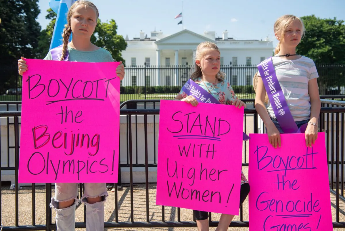 Young demonstrators with the group Stanton Public Policy Center's Purple Sash Revolution hold a rally in support of Uyghur women and call to boycott the 2022 Olympic Games in Beijing during a protest at Lafayette Park outside the White House in Washington, on May 27, 2021. (Saul Loeb/AFP via Getty Images)