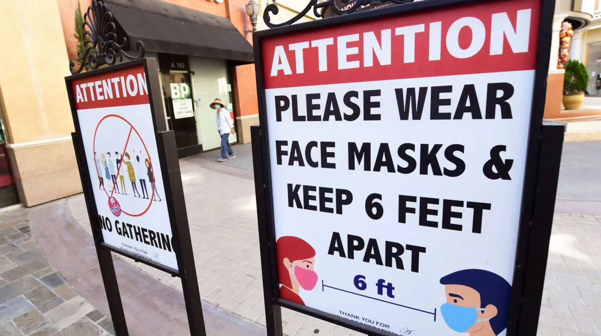 Signs reminding people of social distancing and wearing face masks remain at a mall in California June 14, 2021. (Frederic J. Brown/AFP via Getty Images)
