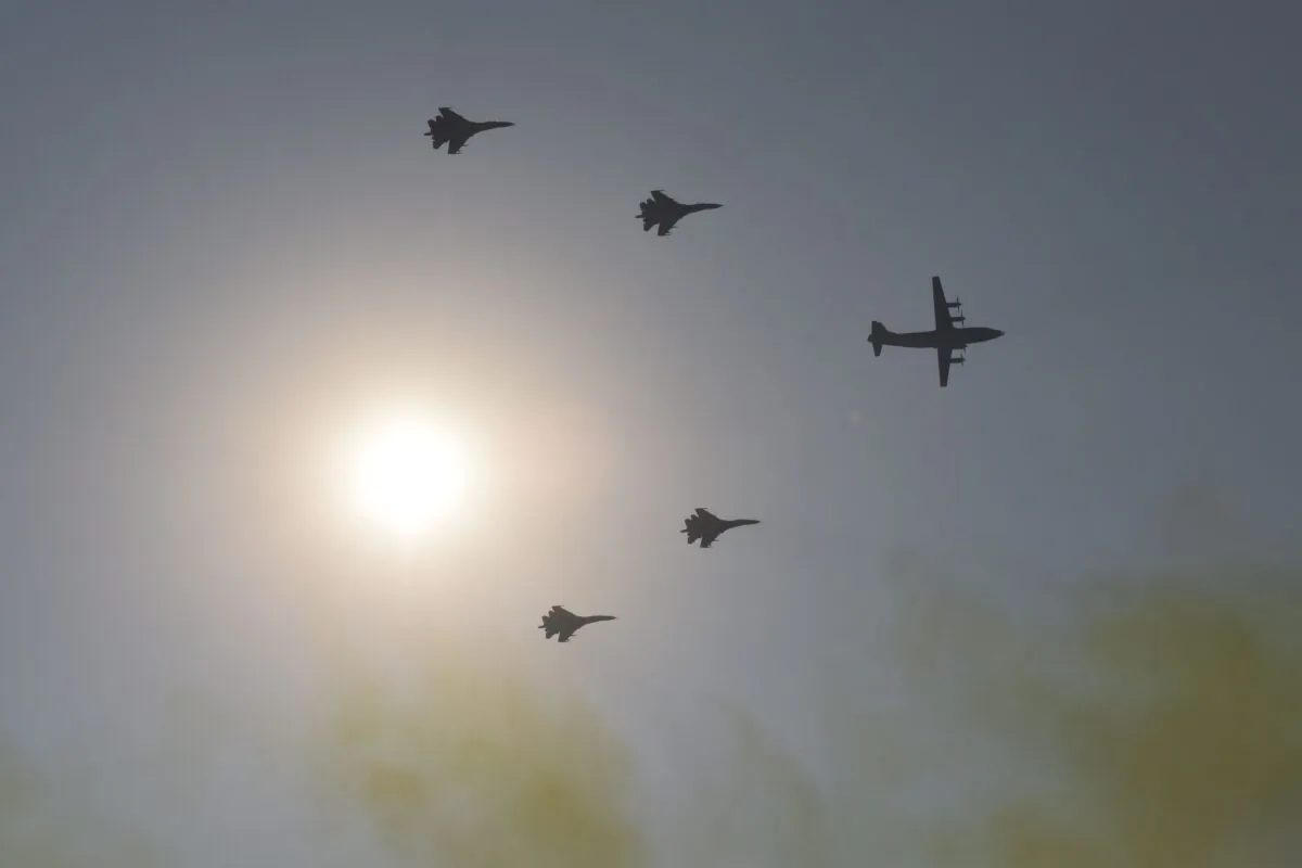 A Y-8 transport aircraft leading J-11 air superiority fighters fly over Beijing on Oct. 1, 2019. (Greg Baker/AFP via Getty Images)