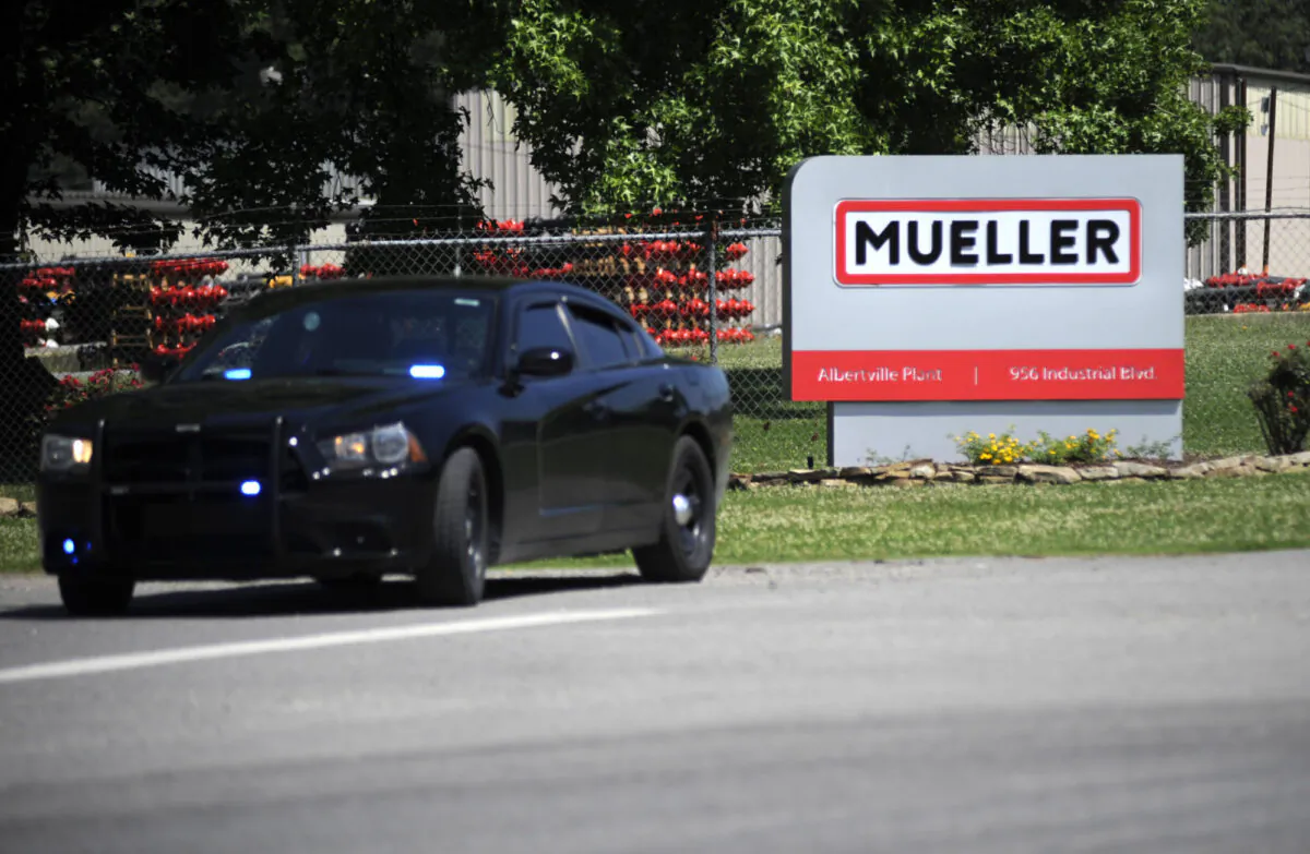 A police car guards the entrance to a Mueller Co. fire hydrant plant where police said multiple people were shot to death and others were wounded in Albertville, Ala., on June 15, 2021. (Jay Reeves/AP Photo)