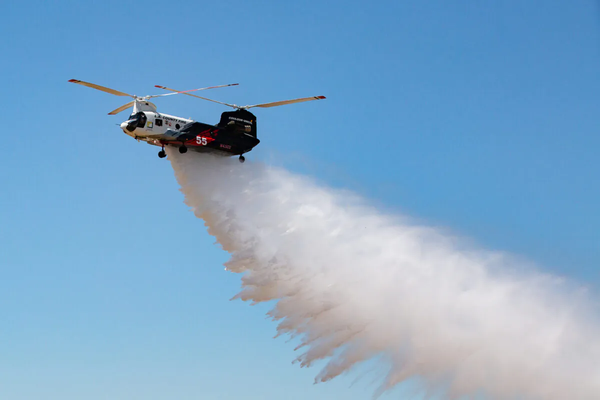 Orange County Fire Authority and partners Ventura and Los Angeles County fire departments gather for the release of a new Cu-47 Helitanker twin rotor helicopter capable of releasing 3,000 gallons of fire retardant upon wildfires. Los Alamitos, Calif., on June 14, 2021. (John Fredricks/The Epoch Times)