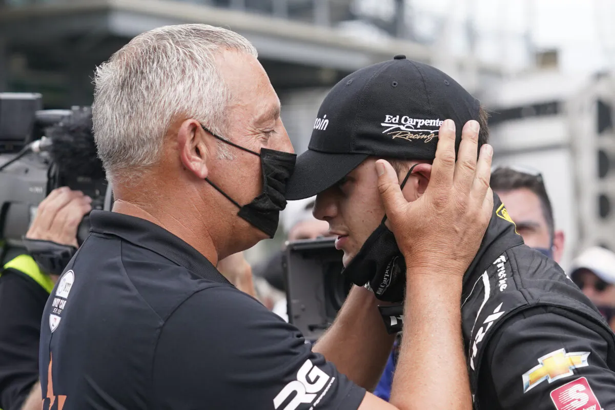 Marijn van Kalmthout talks with is son, Rinus VeeKay, at Indianapolis Motor Speedway in Indianapolis, Sunday, May 23, 2021. (Darron Cummings/AP Photo)