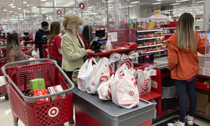 A customer wears a mask as she waits to get a receipt at a register in a Target store in Vernon Hills, Ill., Sunday, May 23, 2021. (Nam Y. Huh/AP Photo)
