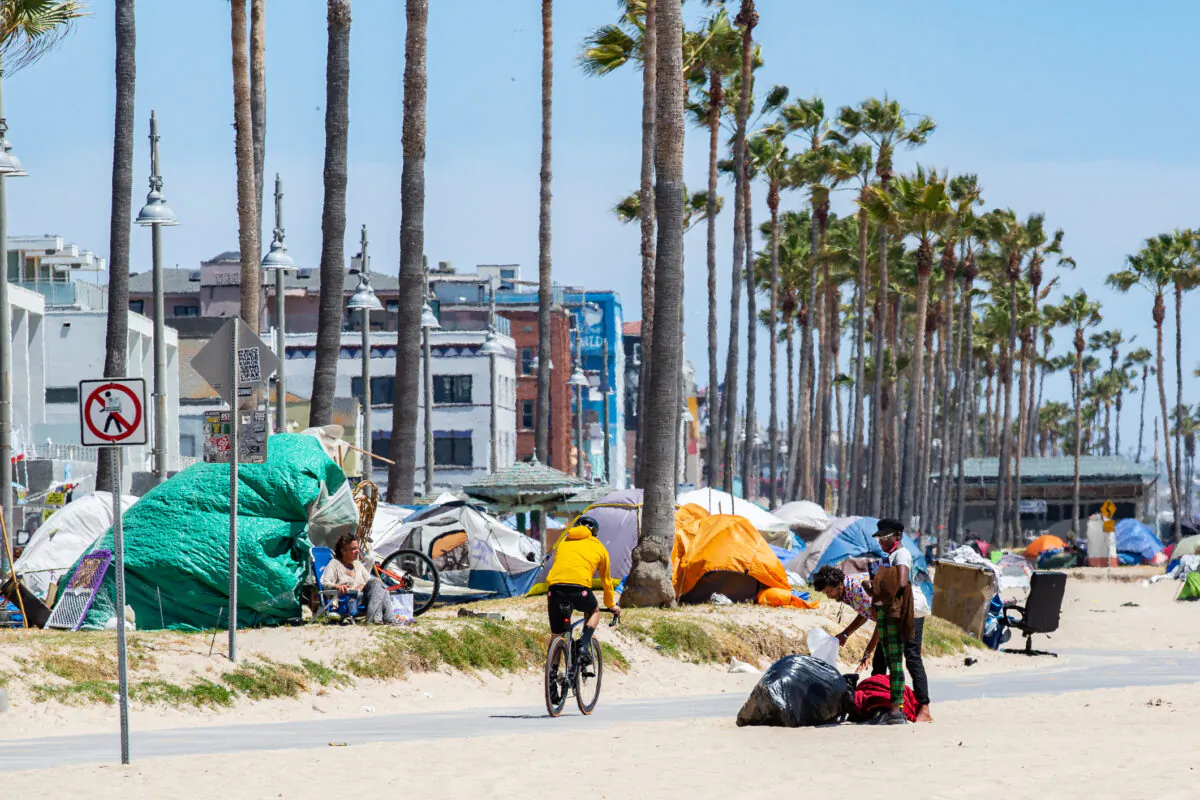 Homeless individuals in Venice Beach, Calif., roam around their encampments on June 8, 2021. (John Fredricks/The Epoch Times)