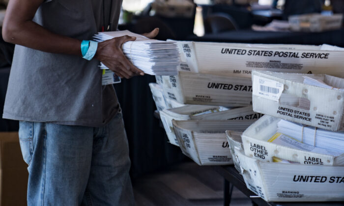 An election worker processes absentee ballots at State Farm Arena in Atlanta on Nov. 2, 2020. (Megan Varner/Getty Images)