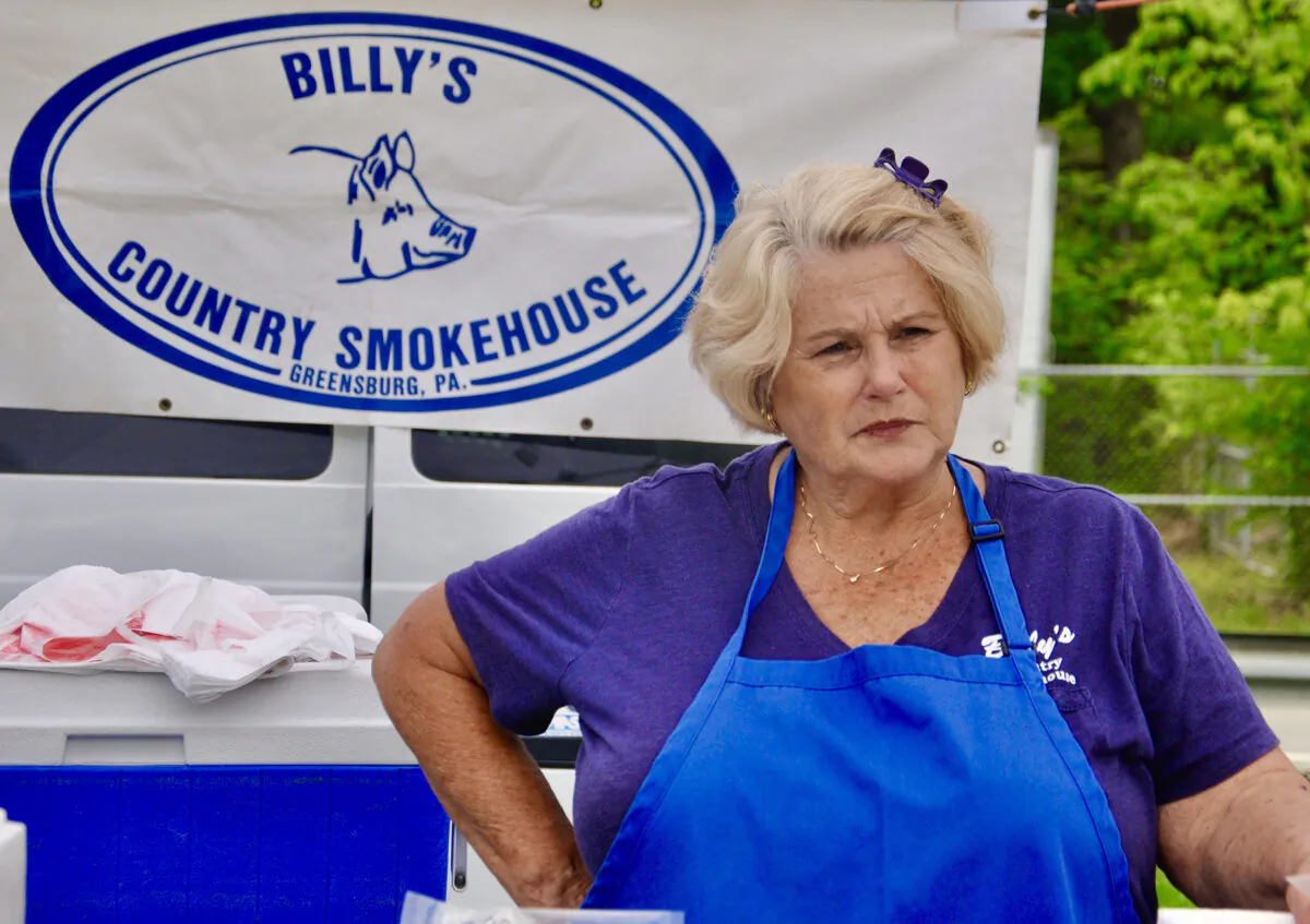 Shirley Stana, owner of Billy’s Country Smokehouse, speaks to customers at a Westmoreland County farmers market. (Shannon Venditti)