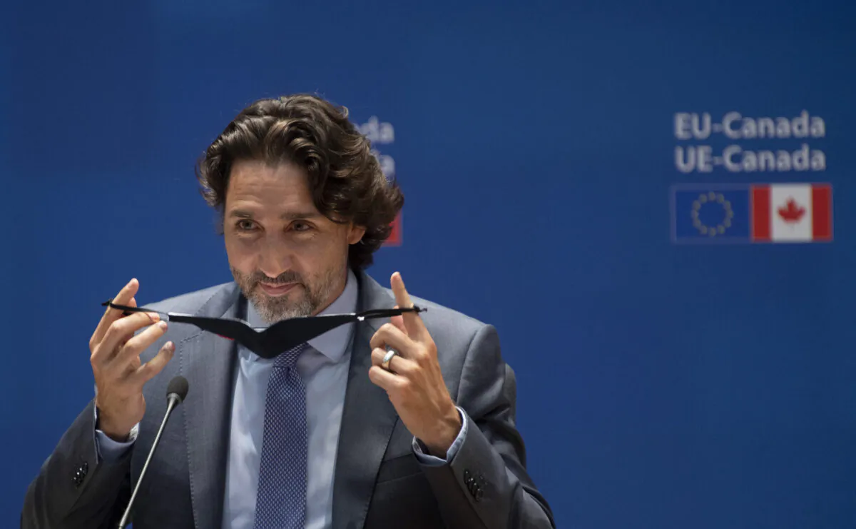 Canadian Prime Minister Justin Trudeau removes his mask at the beginning of the EU-Canada Summit June 14, 2021 in Brussels, Belgium. (The Canadian Press/Adrian Wyld)