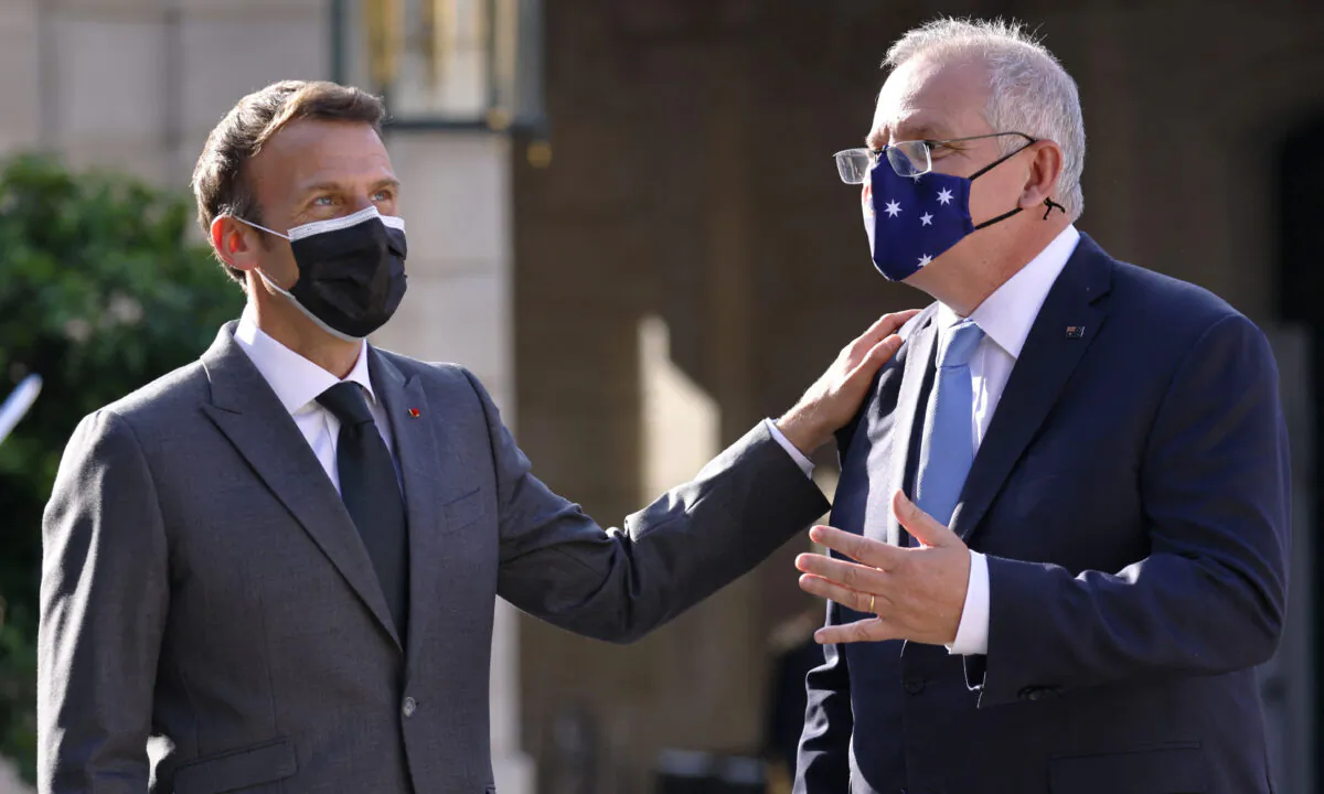 French President Emmanuel Macron (L) greets Australia's Prime Minister Scott Morrison at the Elysee Palace in Paris on June 15, 2021. (Thomas Samso /AFP via Getty Images)