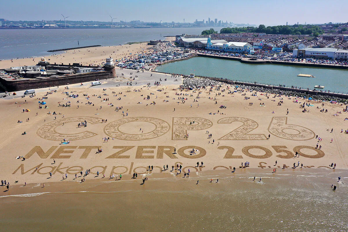 A giant sand art work adorns New Brighton Beach to highlight global warming and the forthcoming Cop26 global climate conference in the Wirral, Merseyside, on May 31, 2021. (Christopher Furlong/Getty Images)