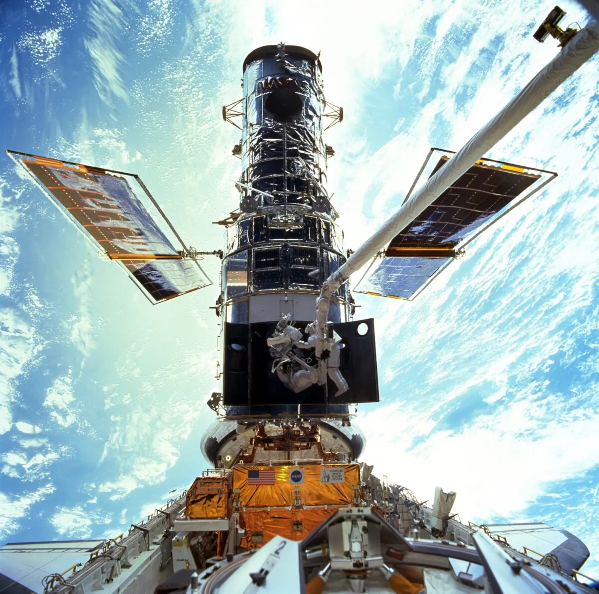 In this image provided by NASA/JSC, astronauts Steven L. Smith and John M. Grunsfeld are photographed during an extravehicular activity (EVA) during the December 1999 Hubble servicing mission of STS-103, flown by Discovery. (NASA/JSC via AP, File)
