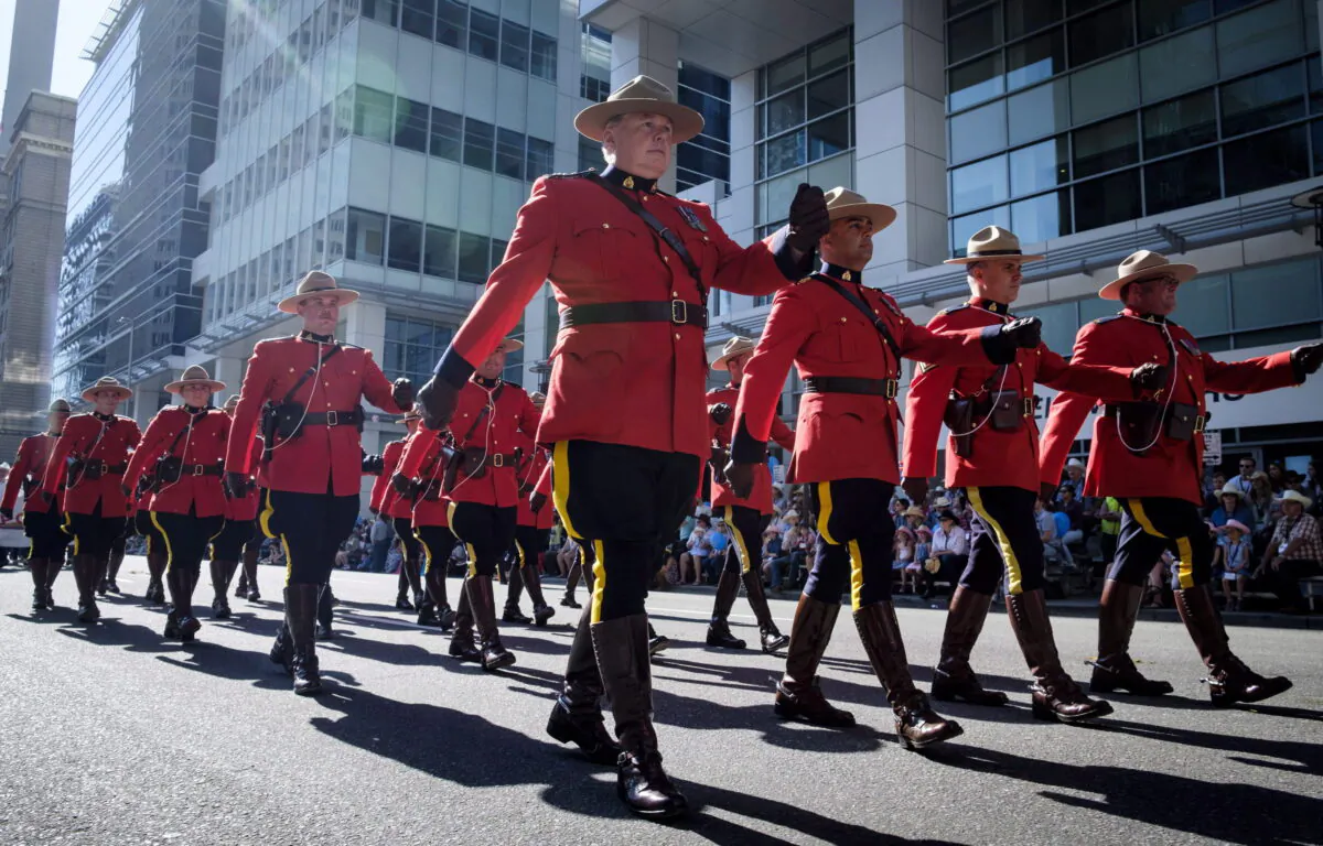 Members of the RCMP march during the Calgary Stampede parade in Calgary on July 6, 2018. (The Canadian Press/Jeff McIntosh)