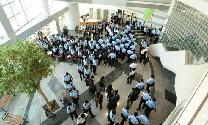 Police officers conduct a raid at the Apple Daily office in Hong Kong, China, on June 17, 2021. (Apple Daily via Getty Images)