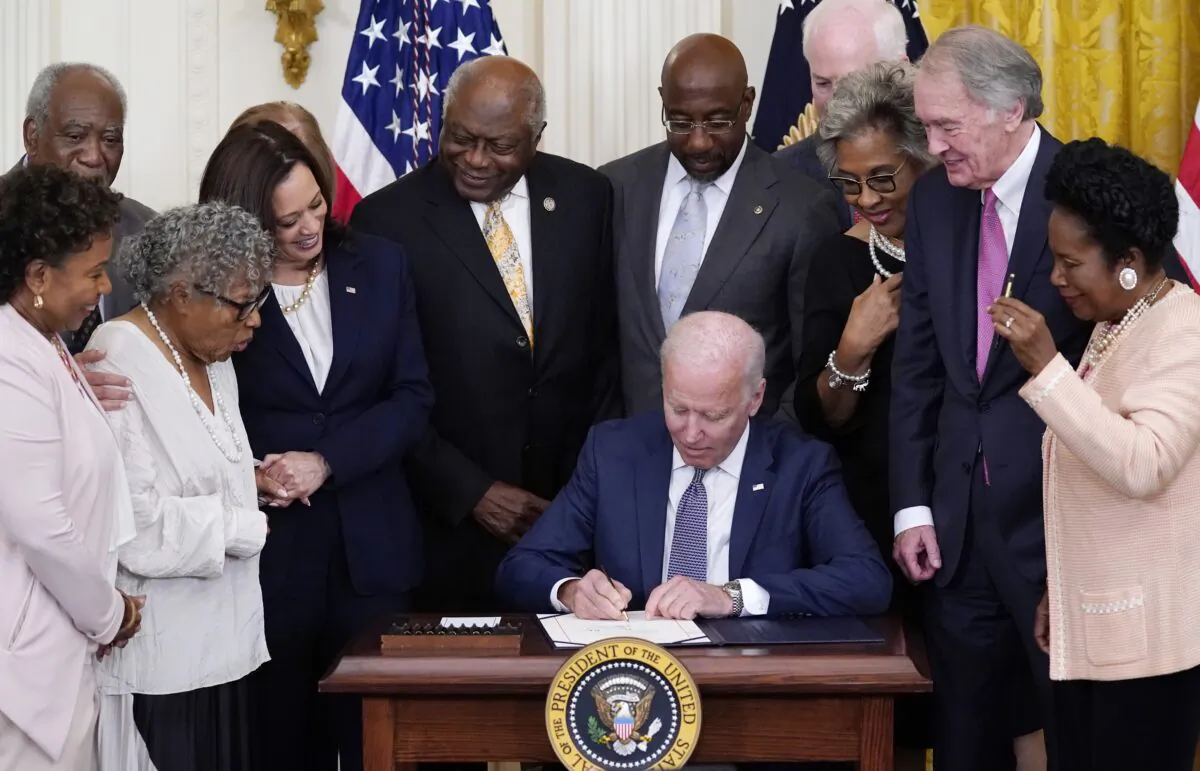 President Joe Biden signs the Juneteenth National Independence Day Act, in the East Room of the White House on June 17, 2021. (Evan Vucci/AP Photo)
