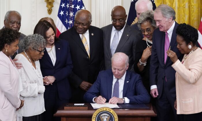 President Joe Biden signs the Juneteenth National Independence Day Act, in the East Room of the White House on June 17, 2021. (Evan Vucci/AP Photo)