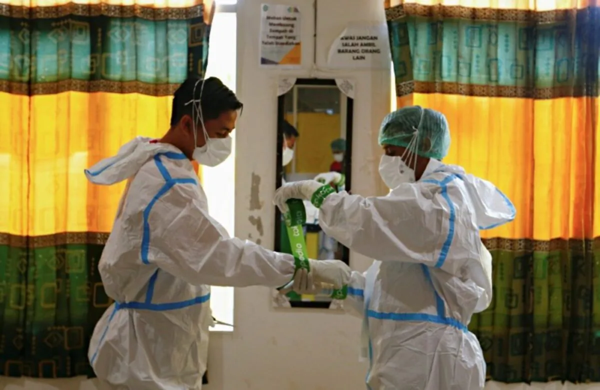 Health care workers wearing PPE (personal protective equipment) prepare themselves to treat patients at a hospital for COVID-19 in Jakarta, Indonesia, on June 17, 2021. (Ajeng Dinar Ulfiana/Reuters)