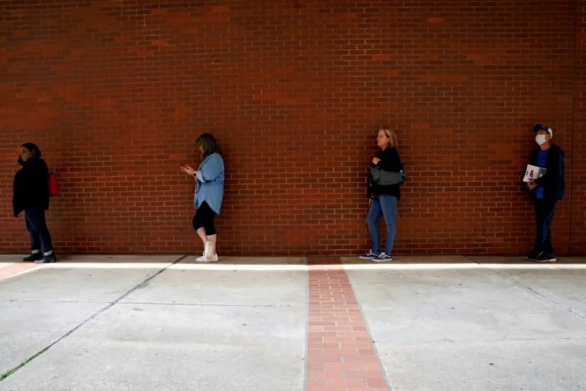 People who lost their jobs wait in line to file for unemployment benefits, following an outbreak of the coronavirus disease, at Arkansas Workforce Center in Fort Smith, Ark., on April 6, 2020. (Nick Oxford/Reuters)