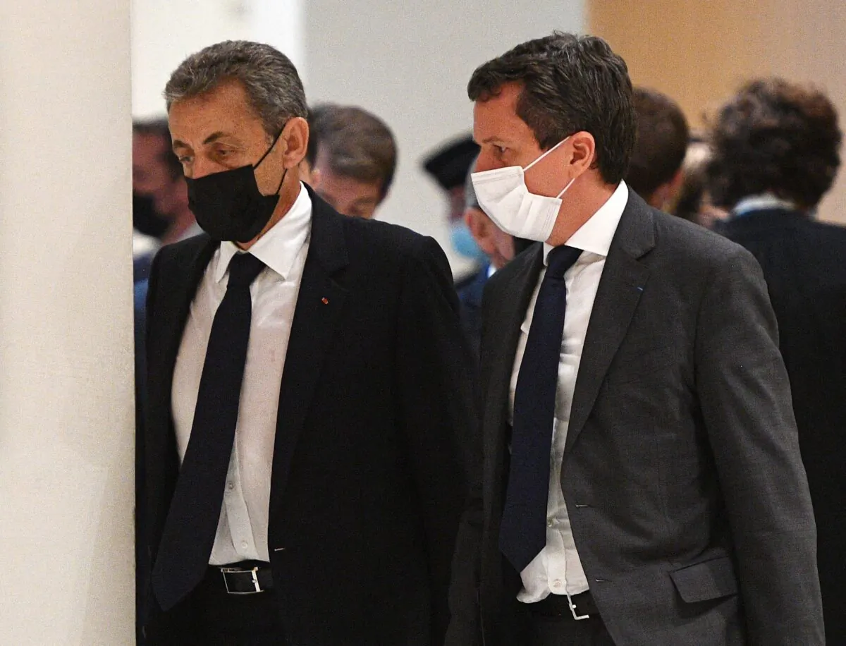 Former French President Nicolas Sarkozy (L) walks during a hearing of the so-called Bygmalion case trial which sees him charged with illicit financing for his failed 2012 re-election campaign, in Paris, France, on June 15, 2021. (Christophe Archambault/AFP via Getty Images)