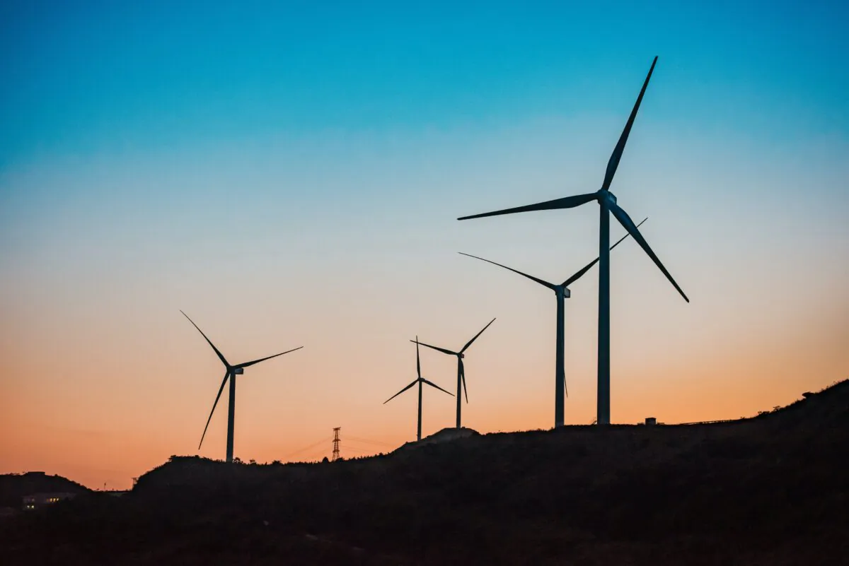 Wind turbines in twilight. (Unsplash)