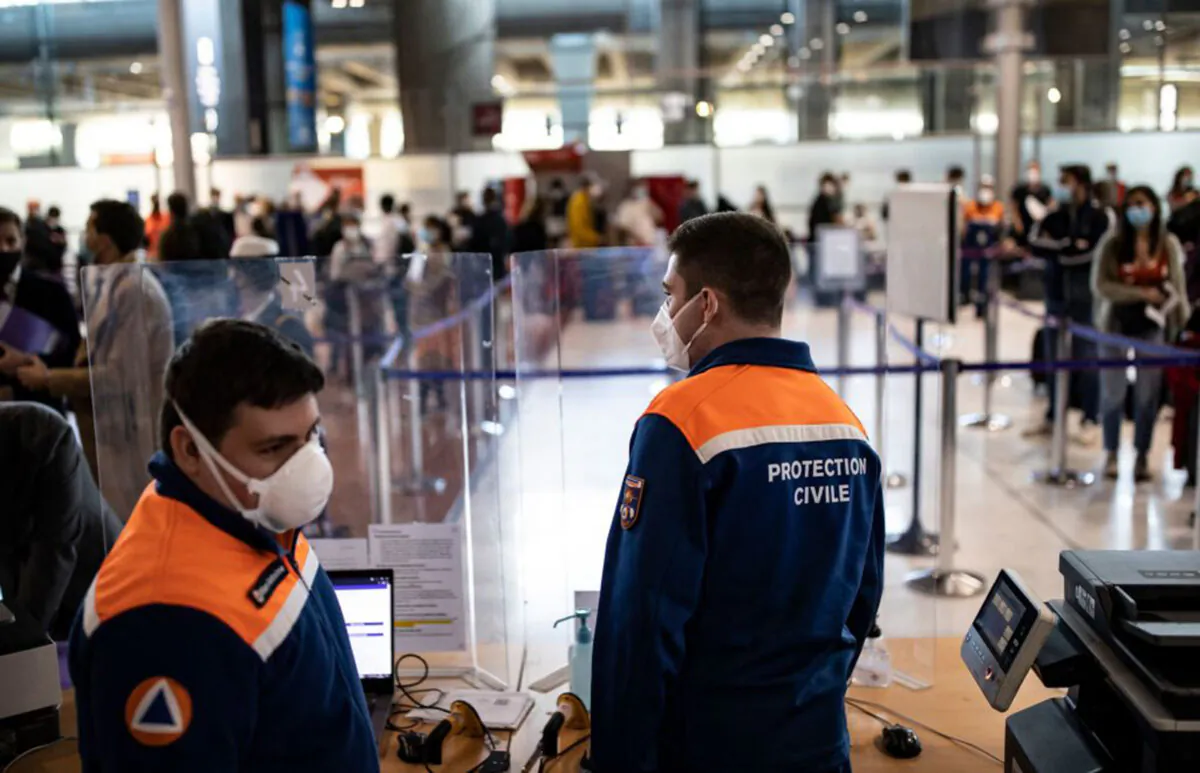 Members of the Civil Protection man a COVID-19 control point where passengers from specific countries register for COVID-19 tests upon their arrival at Roissy Charles de Gaulle airport in Roissy near Paris, France, on April 25, 2021. (Ian Langsdon/Pool/AFP via Getty Images)