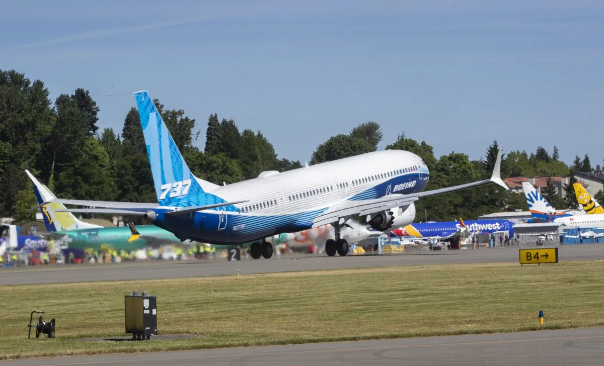 The final version of the 737 MAX, the MAX 10, passes other 737 MAX planes as it takes off from Renton Airport in Renton, Wash., on June 18, 2021. (Ellen M. Banner/The Seattle Times via AP, Pool)
