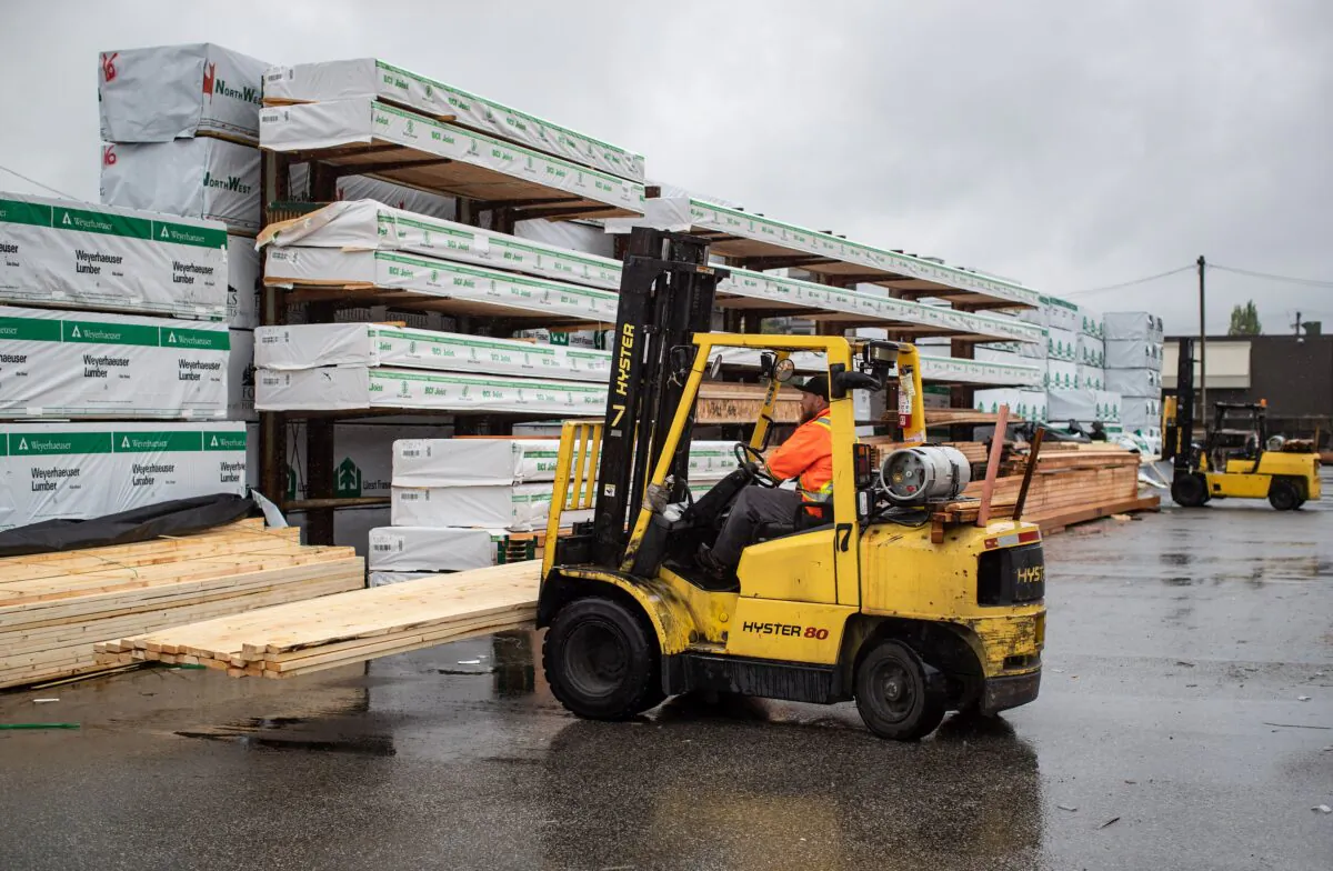 A worker uses a forklift to move lumber at Haney Builders’ Supplies in Maple Ridge, B.C., on June 12, 2020. (The Canadian Press/Darryl Dyck)