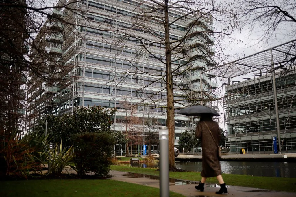 A pedestrian walks past an office block that houses the offices of China's CGTN Europe (China Global Television Network), in Chiswick Park, west London, on Feb. 4, 2021. The UK's broadcast regulator on Aug. 26 revoked the license of Chinese news network CGTN after finding its state-backed ownership structure flouted British law, and warned of punishment ahead after it aired an alleged forced confession. (Tolga Akmen/AFP via Getty Images)