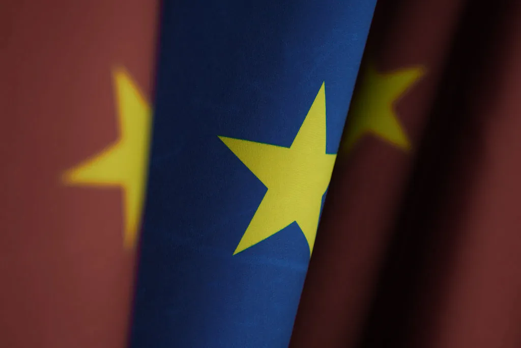 Flags of communist China and the European Union stand at the Chancellery in Berlin on Jan. 26, 2021. (Sean Gallup/Getty Images)