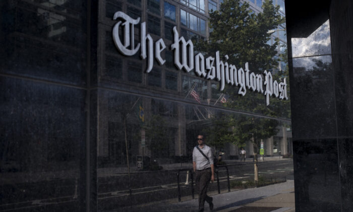 A man walks past The Washington Post in Washington on Aug. 5, 2013. (Brendan Smialowski/AFP via Getty Images)
