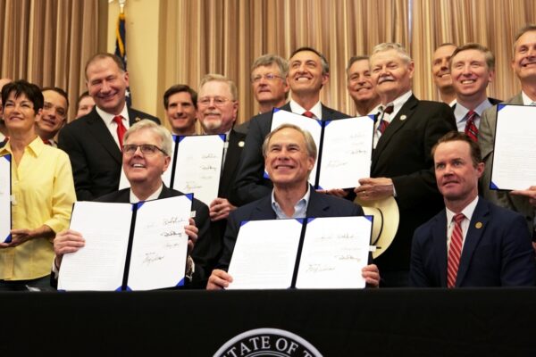 Texas Gov. Greg Abbott shows off a gun rights bill he signed