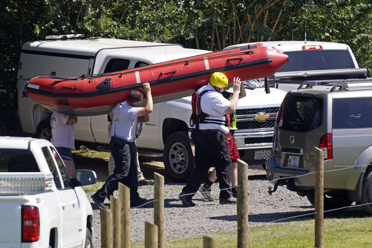 Rescue personnel stage along the Dan River in Eden, N.C., on June 18, 2021. (Gerry Broome/(AP Photo)