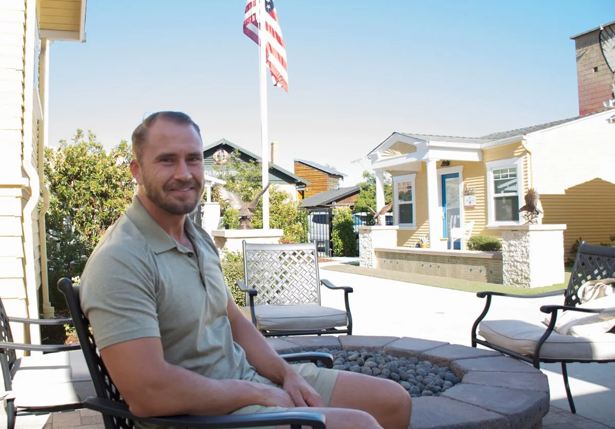 Retired Marine Sergeant Povas Miknaitis sits in the courtyard of Transitional Housing Freedom Station II, by Warrior Foundation Freedom Station, on June 11, 2021. (Jane Yang/The Epoch Times)